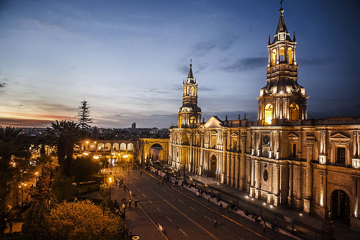 A cathedral lit up at night in Arequipa, one of the best places to visit in South America.